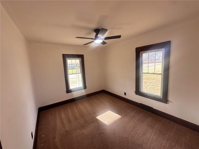 carpeted spare room featuring ceiling fan