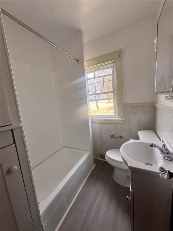 full bathroom with shower / washtub combination, toilet, vanity, and hardwood / wood-style flooring