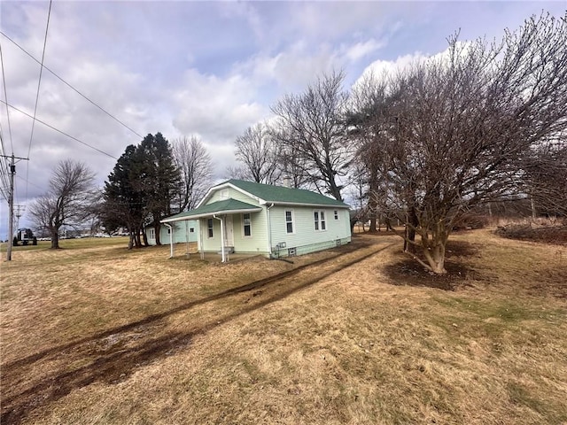 view of home's exterior featuring a porch and a lawn