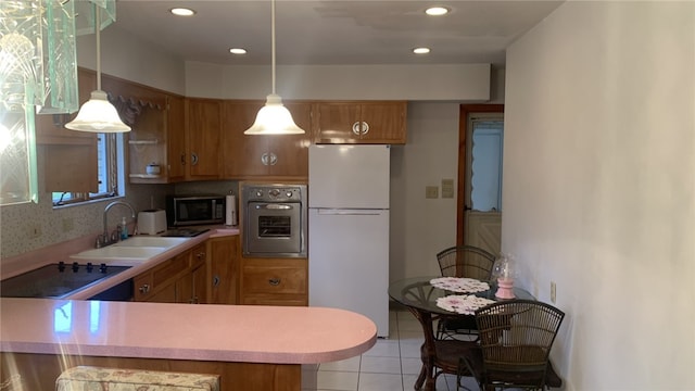 kitchen featuring white refrigerator, sink, decorative backsplash, wall oven, and kitchen peninsula