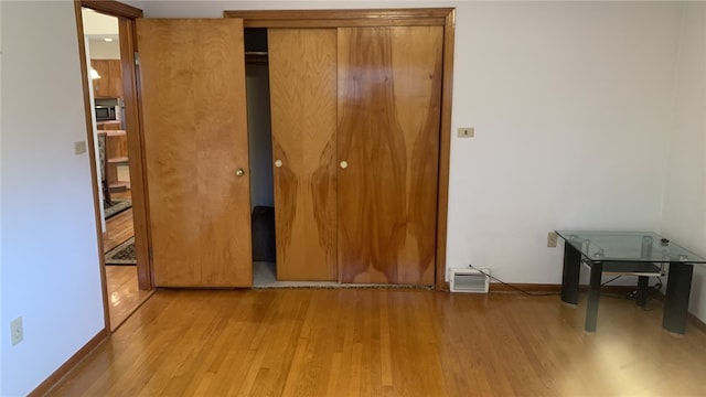 unfurnished bedroom featuring light wood-type flooring