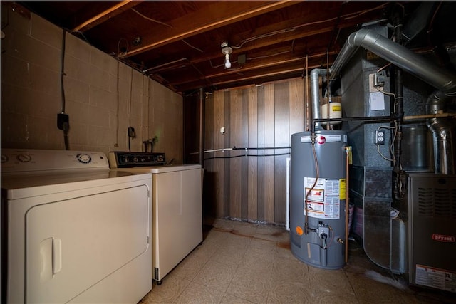 clothes washing area featuring washer and clothes dryer and water heater