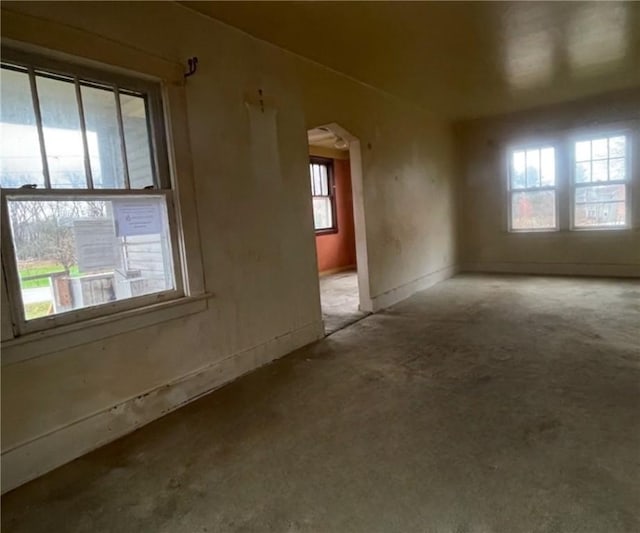 unfurnished room featuring plenty of natural light