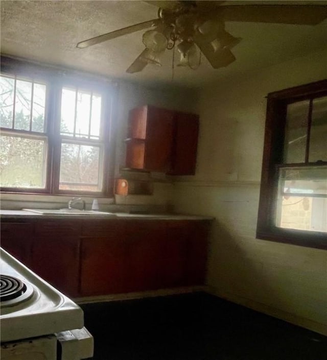 kitchen with a textured ceiling and ceiling fan