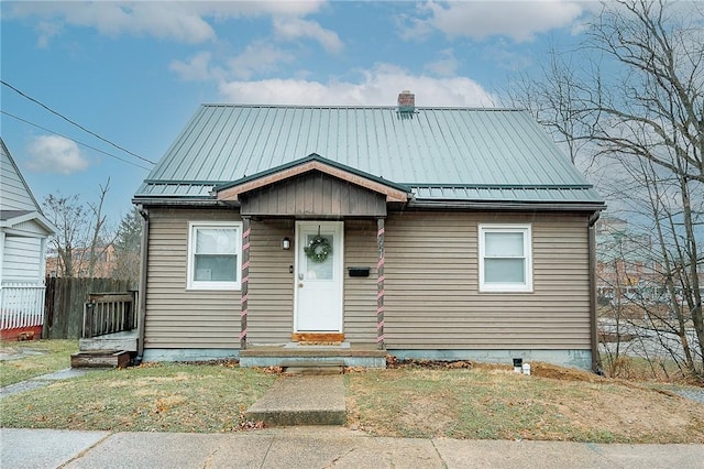 bungalow-style home featuring a front lawn