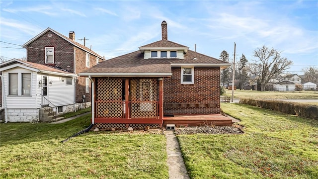 rear view of house with a lawn