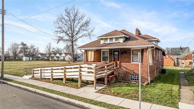 bungalow-style home with a porch and a front lawn