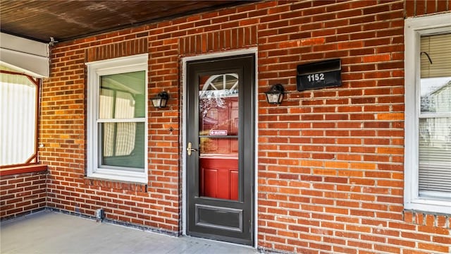 view of exterior entry featuring a porch