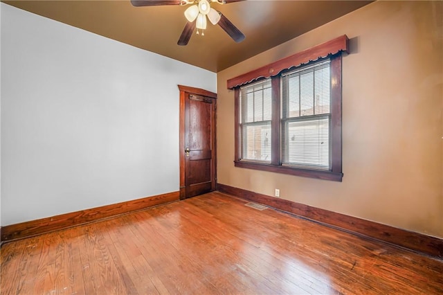 empty room featuring ceiling fan and light wood-type flooring