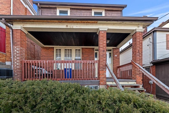 back of property with covered porch