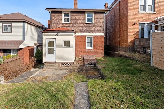 rear view of property featuring a yard