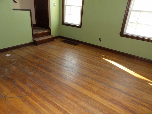 unfurnished room with dark wood-type flooring