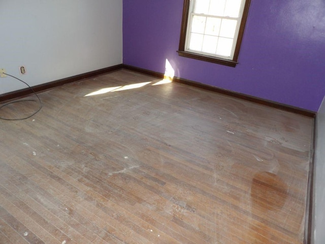 spare room with hardwood / wood-style flooring