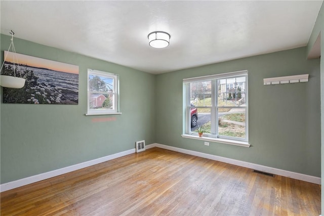 unfurnished room with light hardwood / wood-style flooring