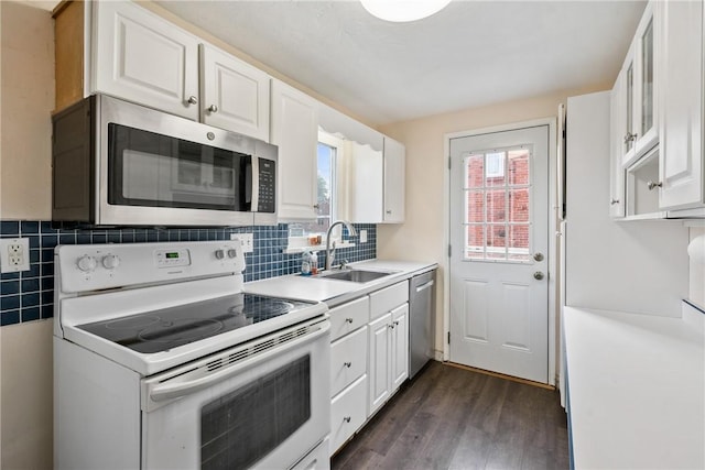 kitchen with white cabinetry, sink, dark hardwood / wood-style floors, and appliances with stainless steel finishes