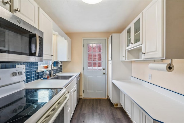 kitchen featuring white cabinets, appliances with stainless steel finishes, dark hardwood / wood-style flooring, and sink