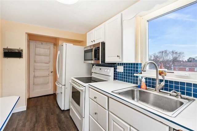 kitchen with white cabinetry, sink, dark wood-type flooring, tasteful backsplash, and white range with electric stovetop