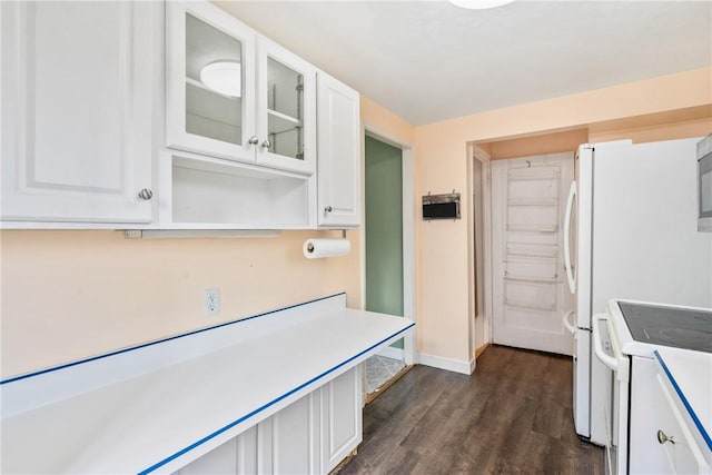 kitchen with white cabinets, dark hardwood / wood-style floors, and electric stove