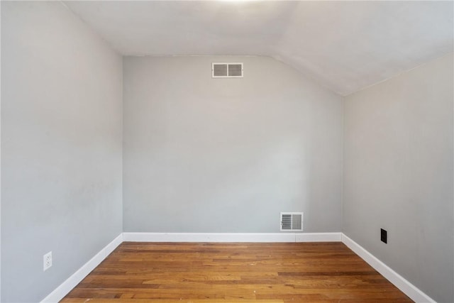 interior space featuring hardwood / wood-style flooring and lofted ceiling