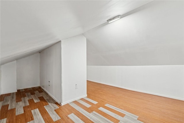 bonus room featuring light hardwood / wood-style flooring and lofted ceiling