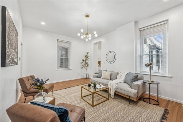 living room with hardwood / wood-style floors and an inviting chandelier