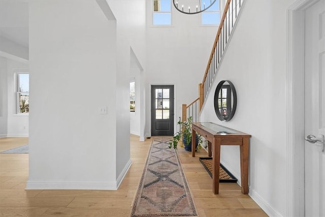 entryway featuring plenty of natural light, light hardwood / wood-style floors, and an inviting chandelier