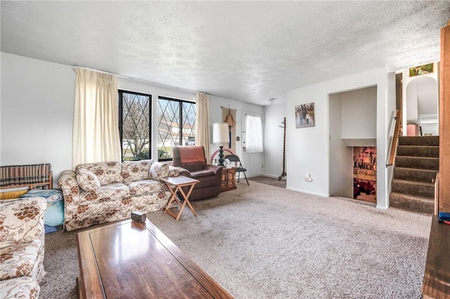 carpeted living room featuring a textured ceiling