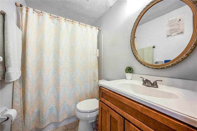 bathroom featuring vanity, a textured ceiling, and toilet