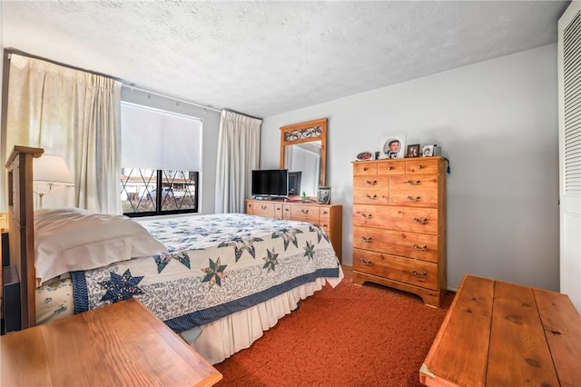 bedroom with carpet flooring and a textured ceiling