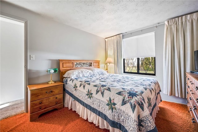 bedroom featuring a textured ceiling and dark carpet