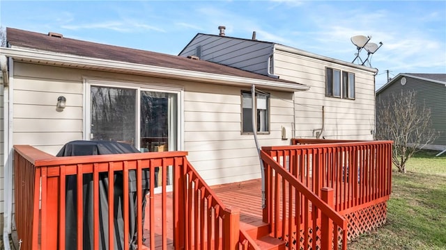 wooden deck with a lawn