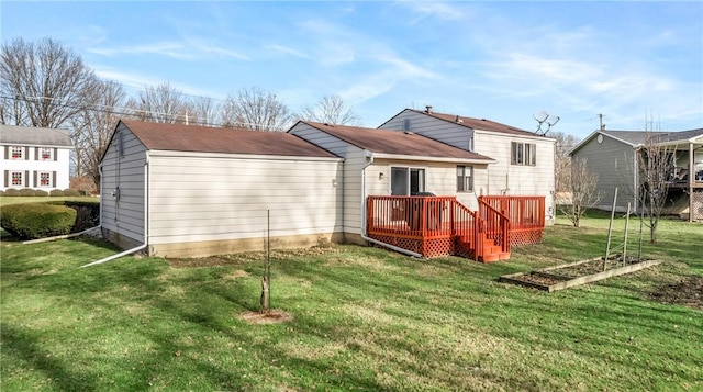 rear view of house featuring a deck and a yard