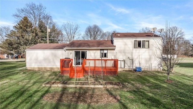 rear view of house featuring a lawn and a wooden deck