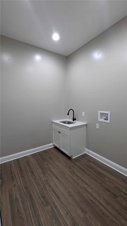 washroom featuring hookup for a washing machine, sink, and dark wood-type flooring