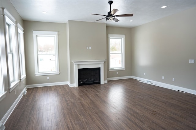 unfurnished living room featuring dark hardwood / wood-style flooring and ceiling fan