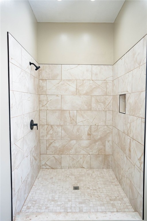 bathroom with tiled shower