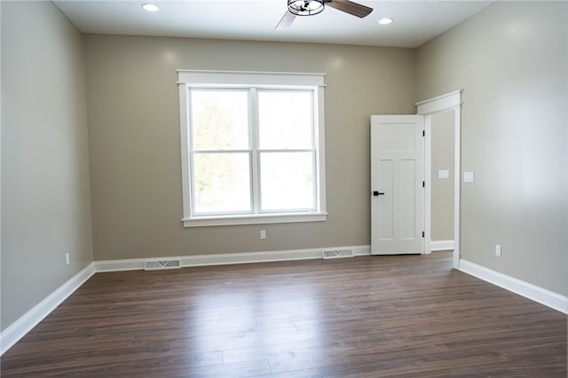 empty room featuring dark hardwood / wood-style floors and ceiling fan