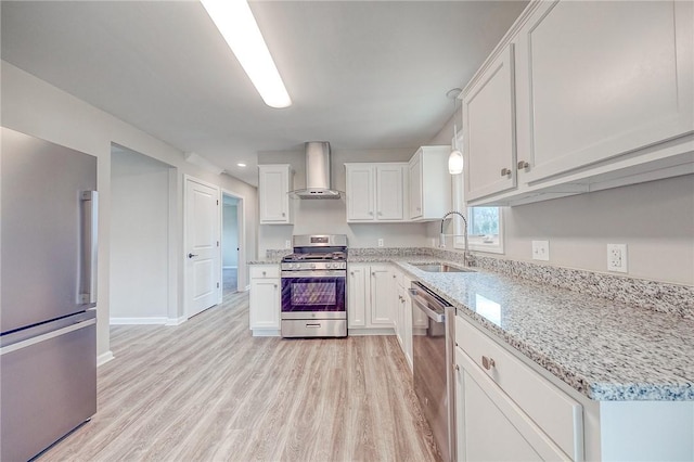 kitchen with white cabinetry, sink, wall chimney exhaust hood, stainless steel appliances, and light stone counters