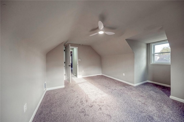 additional living space featuring carpet floors, ceiling fan, and lofted ceiling