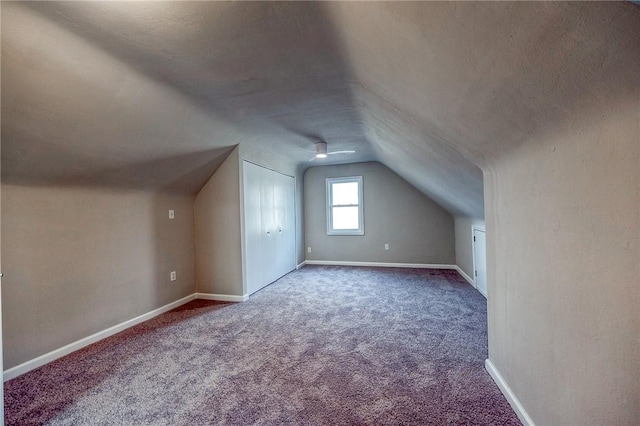 additional living space with carpet floors and vaulted ceiling