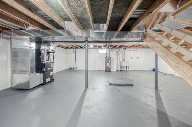 basement with heating unit, water heater, and sink