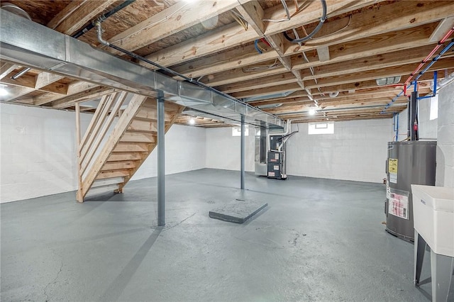 basement featuring heating unit and water heater