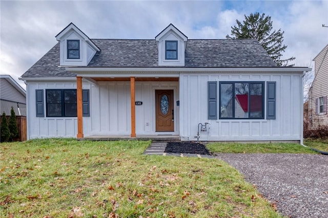 view of front of house with a front yard and a porch