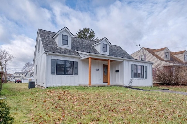 cape cod house featuring covered porch, central AC, and a front lawn