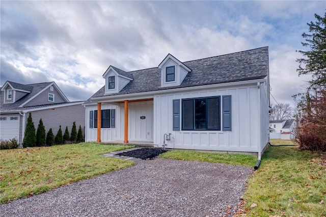 cape cod home featuring a front lawn and covered porch