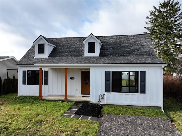 view of front of home featuring covered porch and a front yard