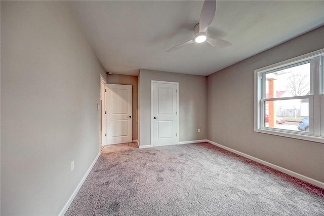 unfurnished bedroom with light colored carpet and ceiling fan