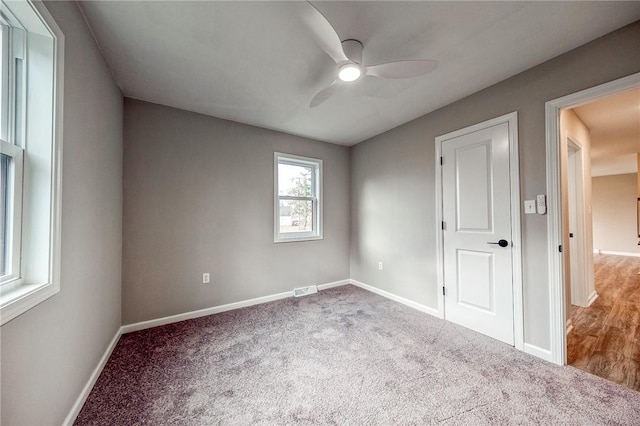 interior space with ceiling fan and carpet floors