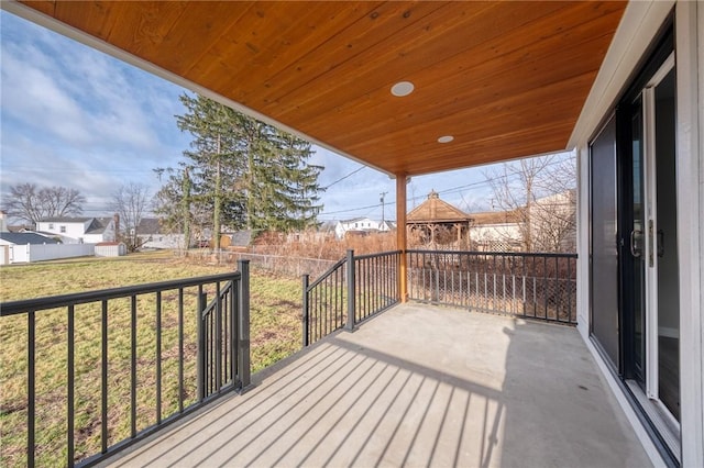 deck with covered porch and a yard