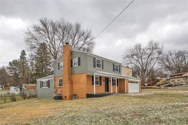 front of property featuring a porch, a garage, and central air condition unit